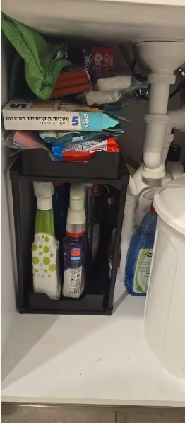 Pull out organiser under a sink with cleaning products